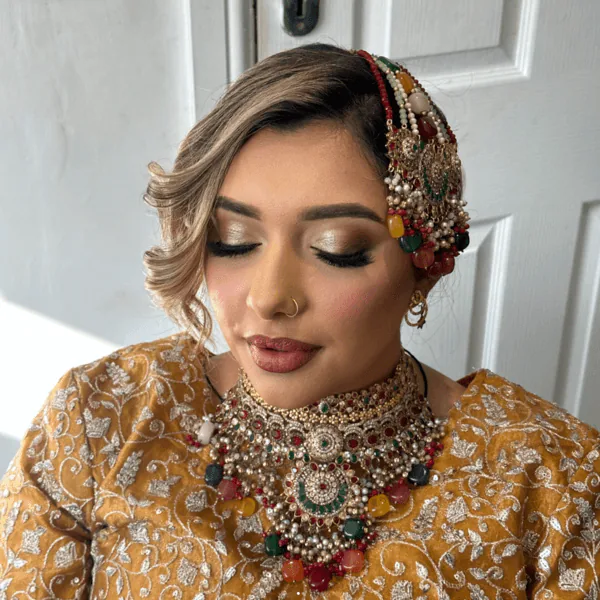 Bride in gold with traditional jewellery and bronze eye makeup